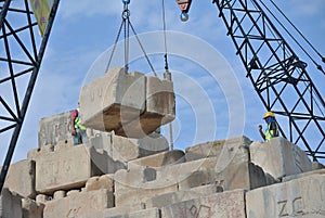 Construction workers stacking the maintain load test block at the construction site